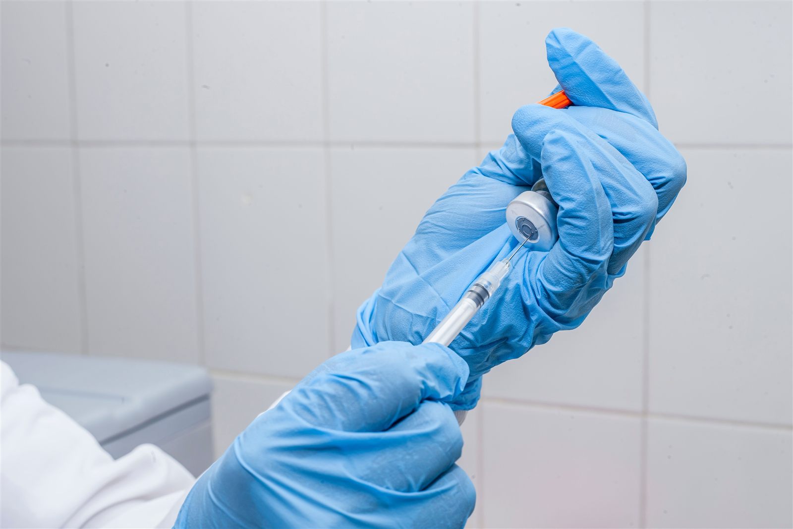 Clinician preparing medication for a guided injection