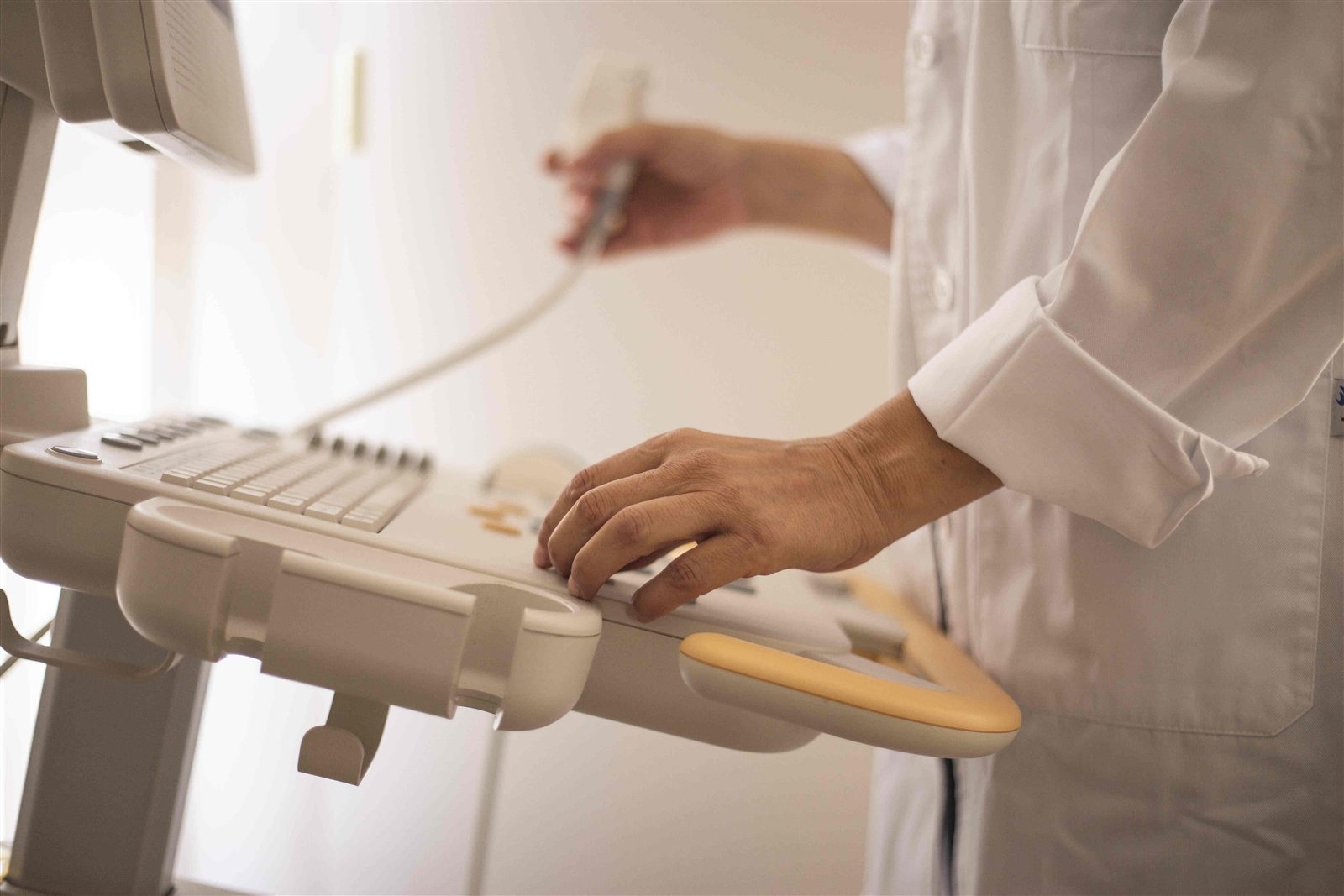 Clinician operating diagnostic ultrasound equipment